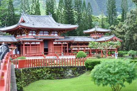 A red, asian styled building in a forest