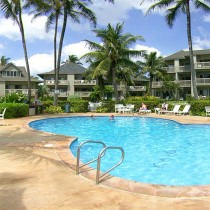 A bean-shaped pool surrounded by buildings at Castle Kaha Lani resort