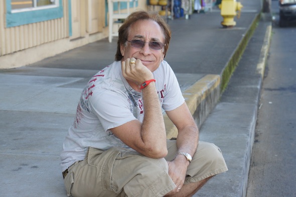 Bruce Fisher poses on a sidewalk