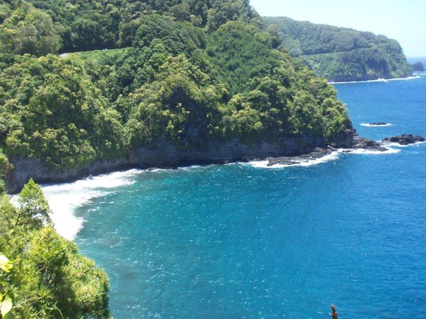 A beach in Hana bordered by a winding road