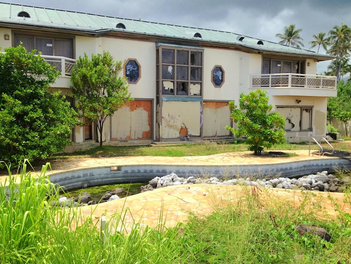 The rear of an abandoned and decrepit mansion