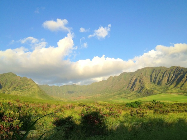 A green valley with a blue sky