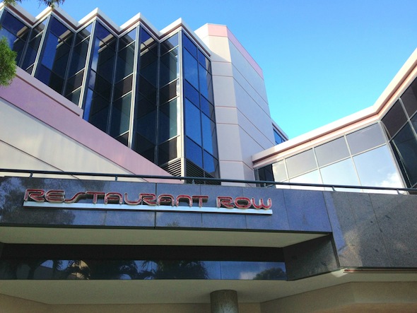 Looking up at a sign that says, “Restaurant Row”