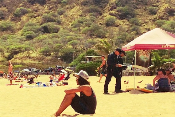 2 Policemen talking to people on the beach