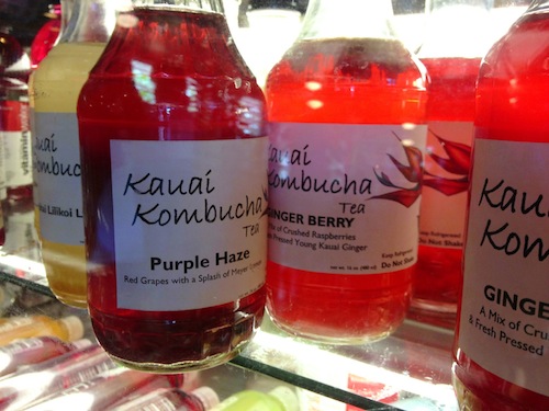 Several bottles of Kauai Kombucha in a refrigerator