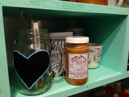 A jar of Aloha Butter peanut butter on a shelf