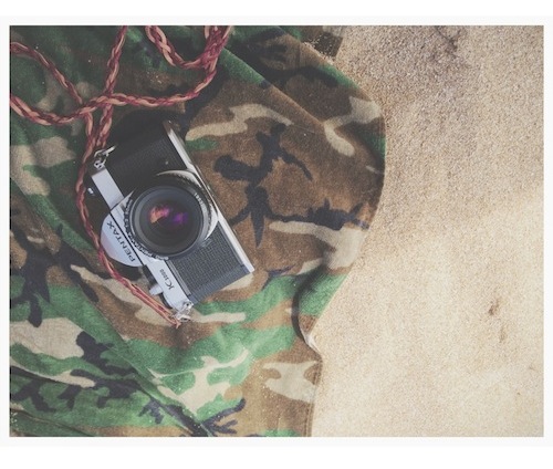 Film camera on a towel at the beach