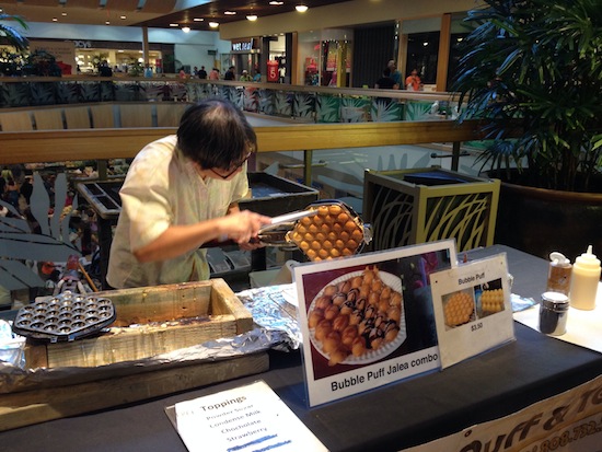 A woman makes bubble puffs at the Windward Mall farmers market