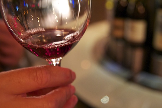 A splash of red wine in a wine glass