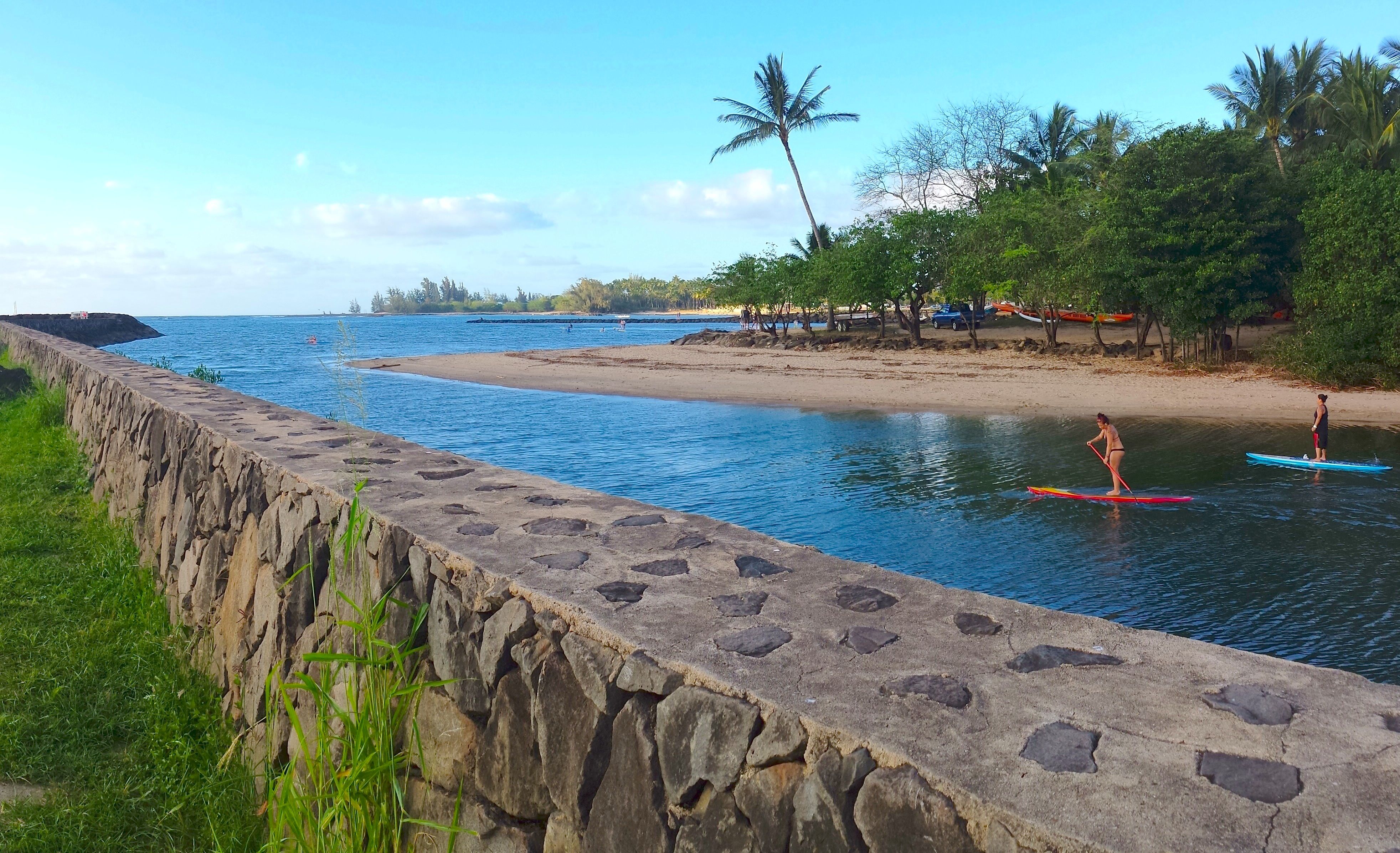 2 Paddleboarders head for the ocean at Haleiwa