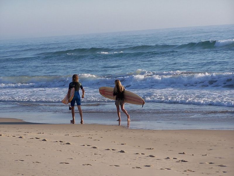 People with surfboards on the beach