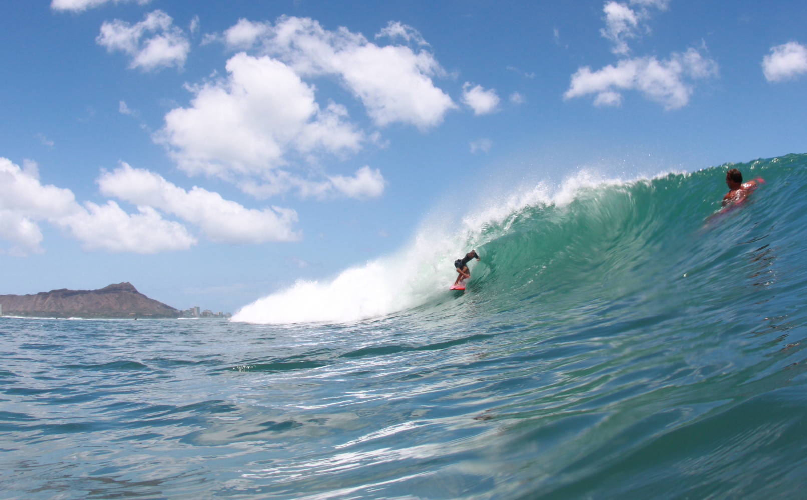 Surfers on a wave