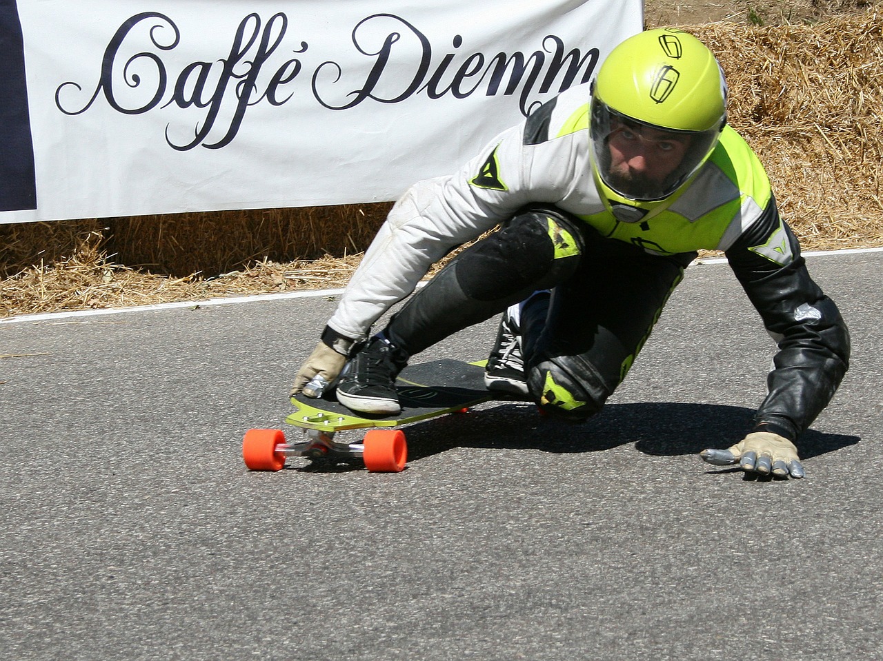 A skateboarder races downlhill