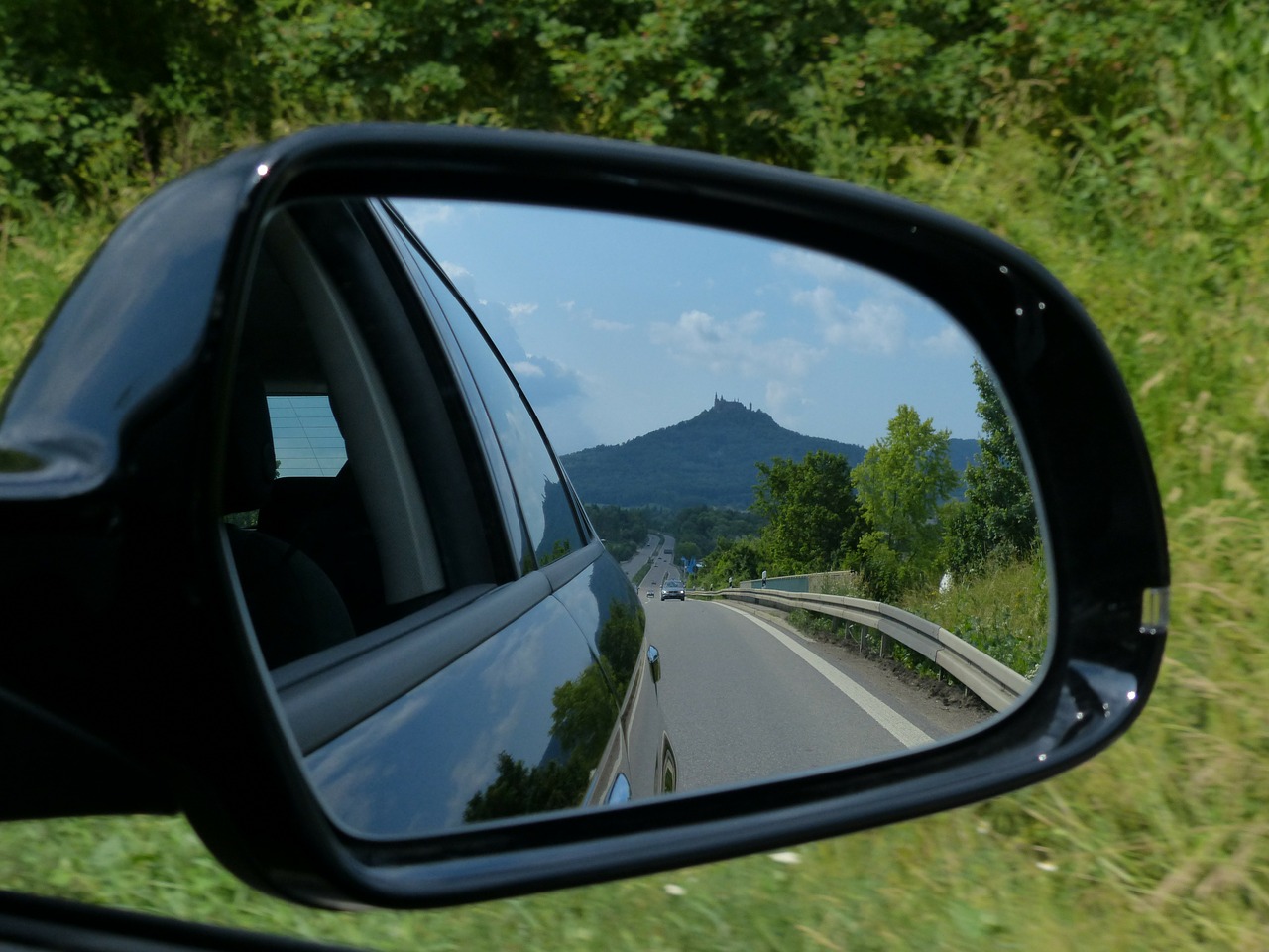 A mountain in a side-view mirror