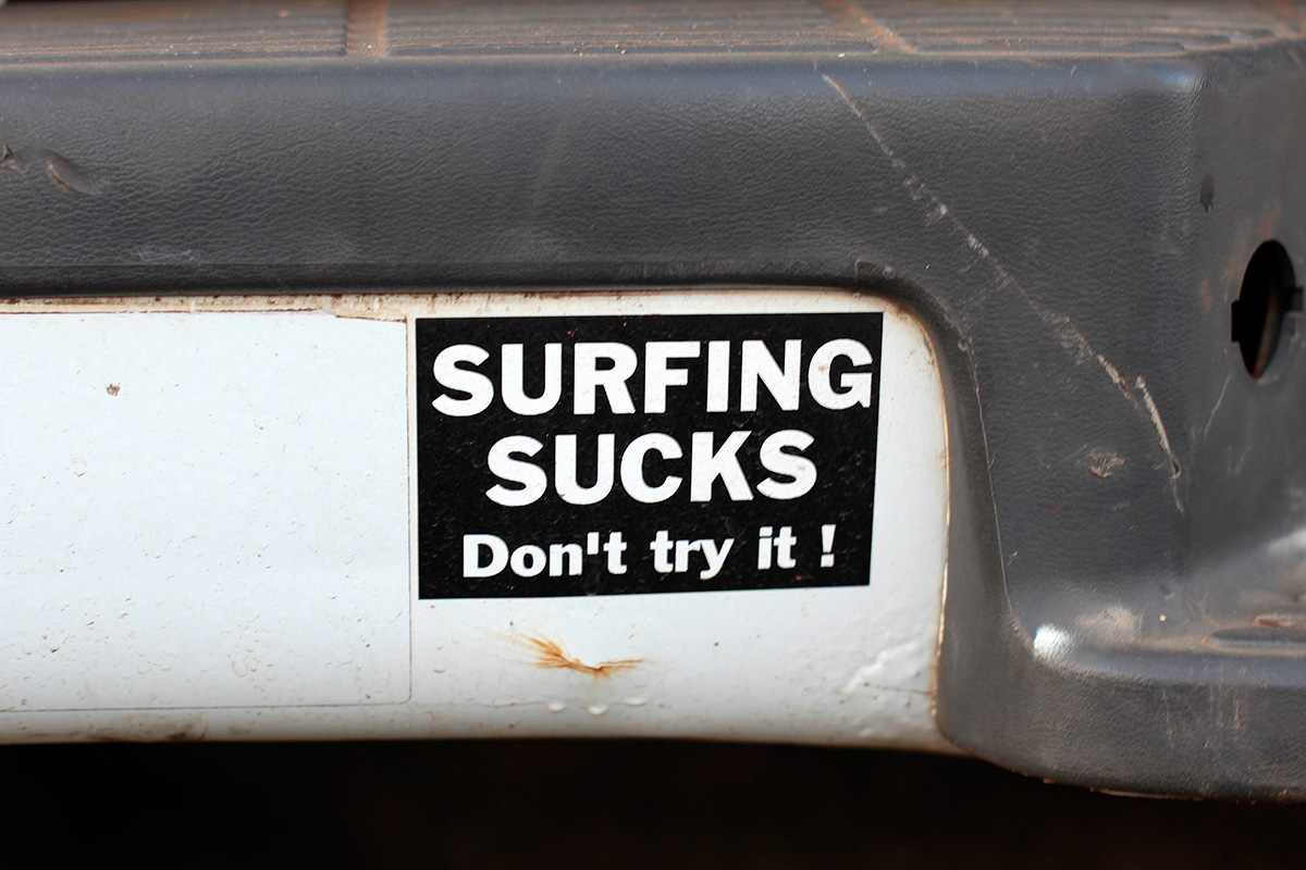 Surfing sucks bumper sticker