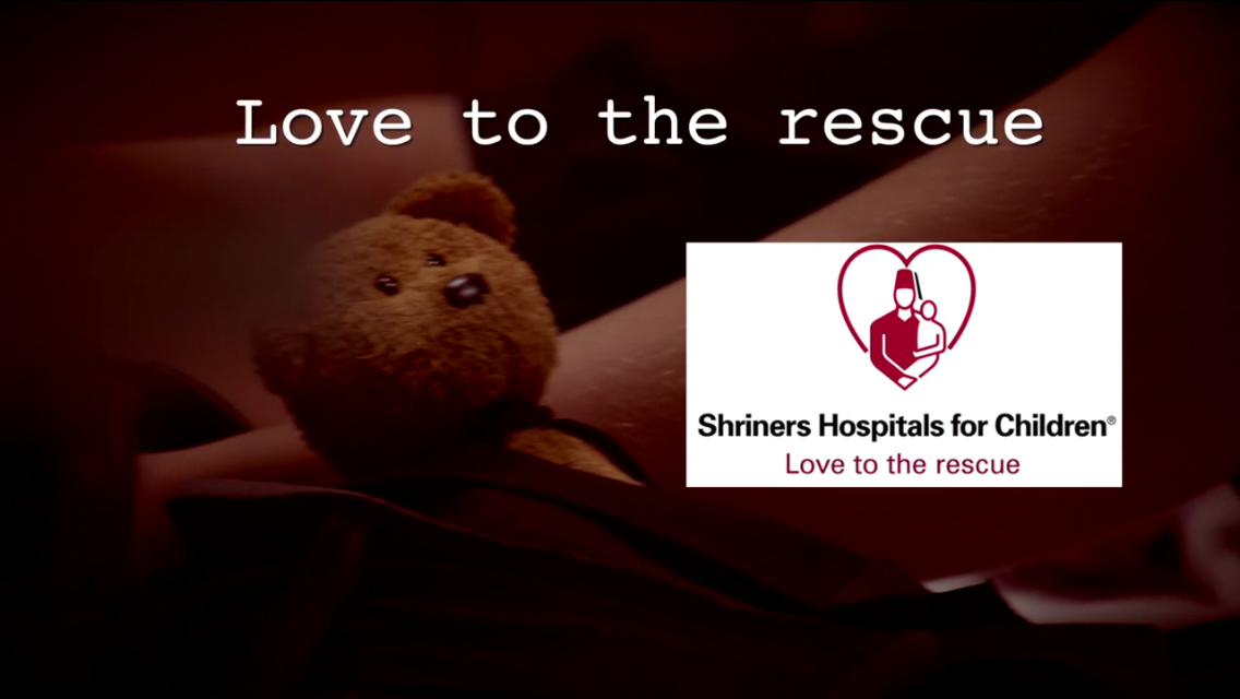 a teddy bear with the shriner's hospitals for children logo