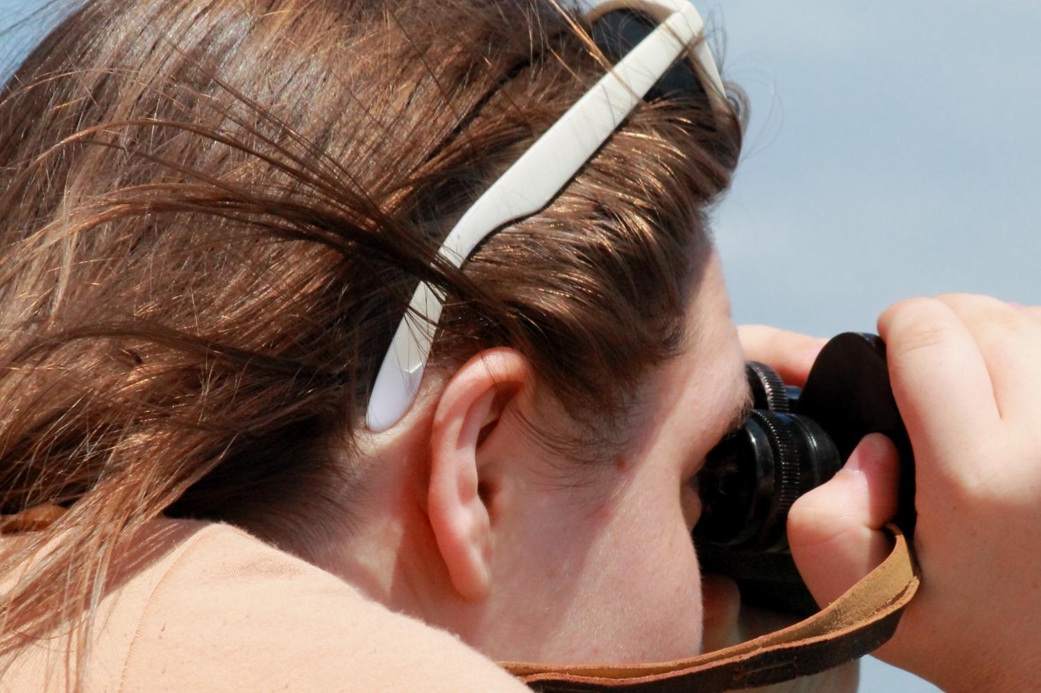 a woman looking through binoculars