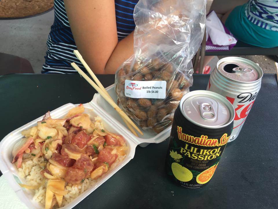 a plate of poke next to drinks