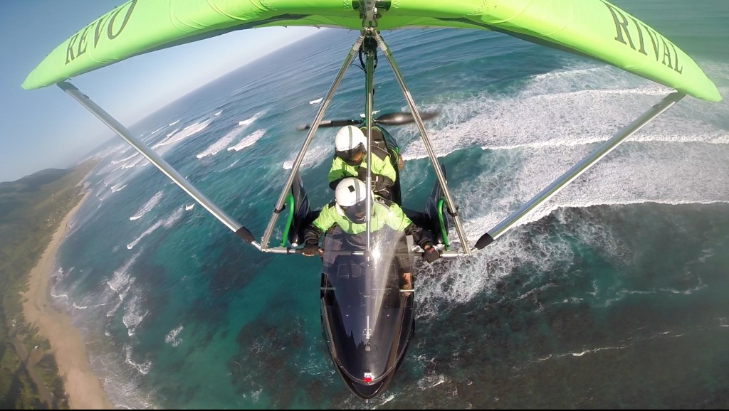 two people in a powered hang glider above the ocean on Oahu