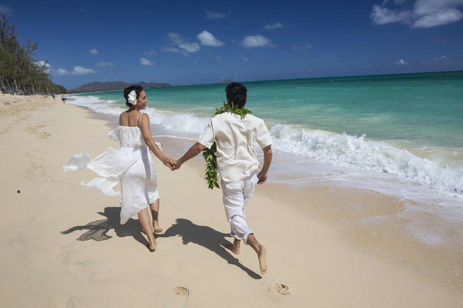 a couple running on the beach
