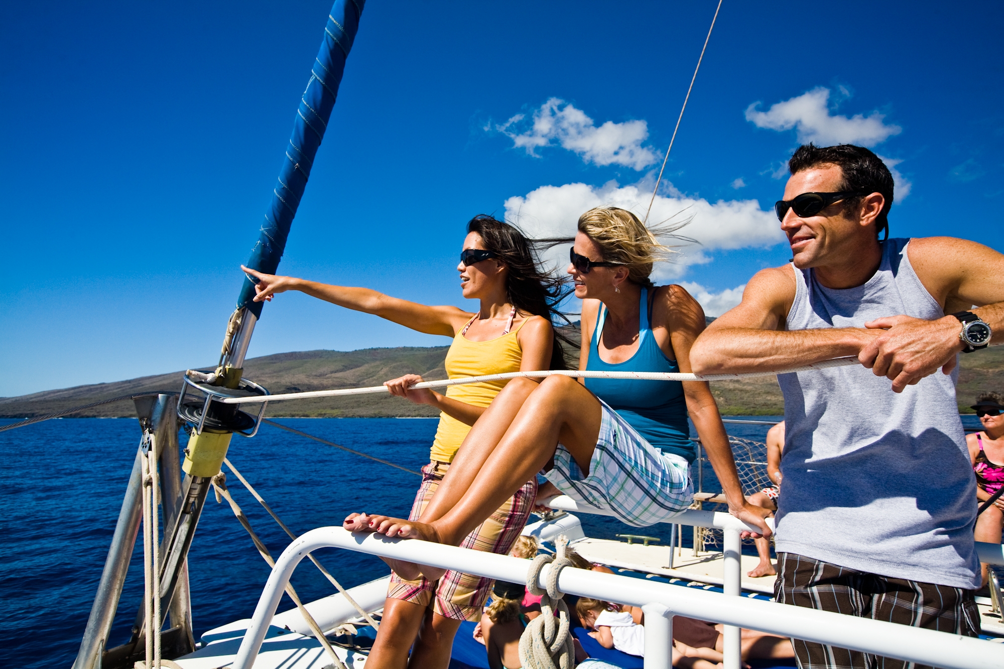 people on a sailboat pointing