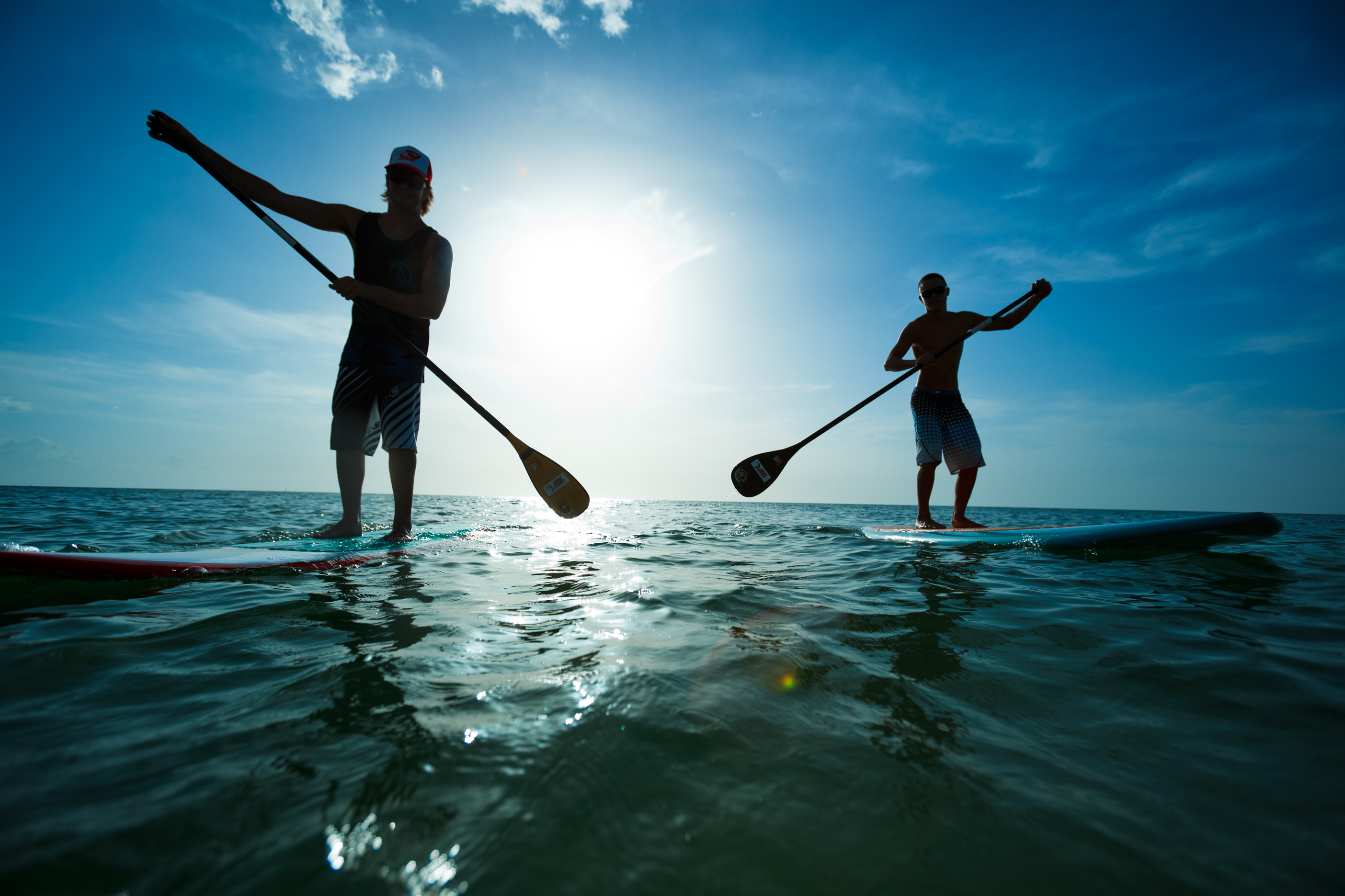 two stand-up paddle boarders on the ocean