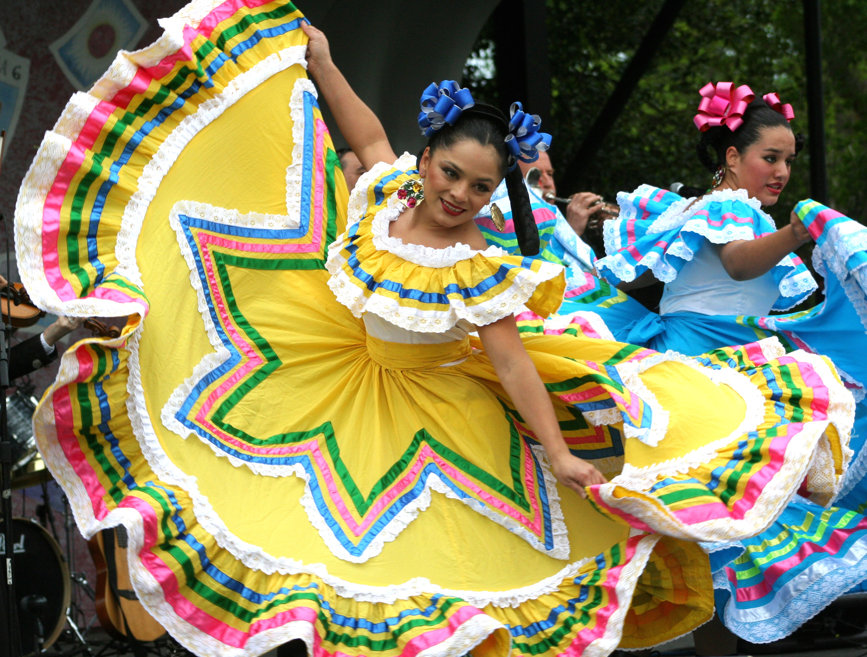 dancers dressed up in mexican dresses dancing