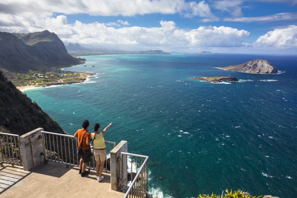 people looking out over Makapuu Lighthouse Trail watching for whales on Oahu