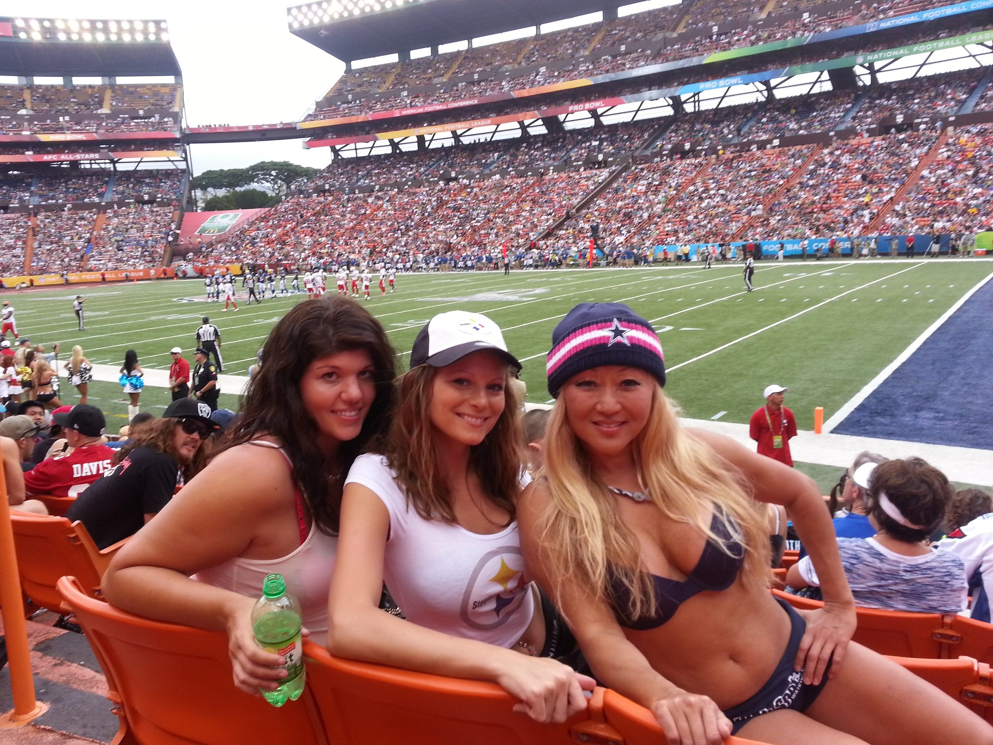 three girls at a football stadium