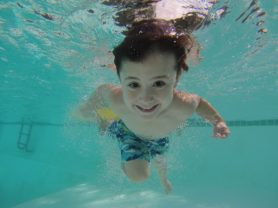 a child swimming in a pool.