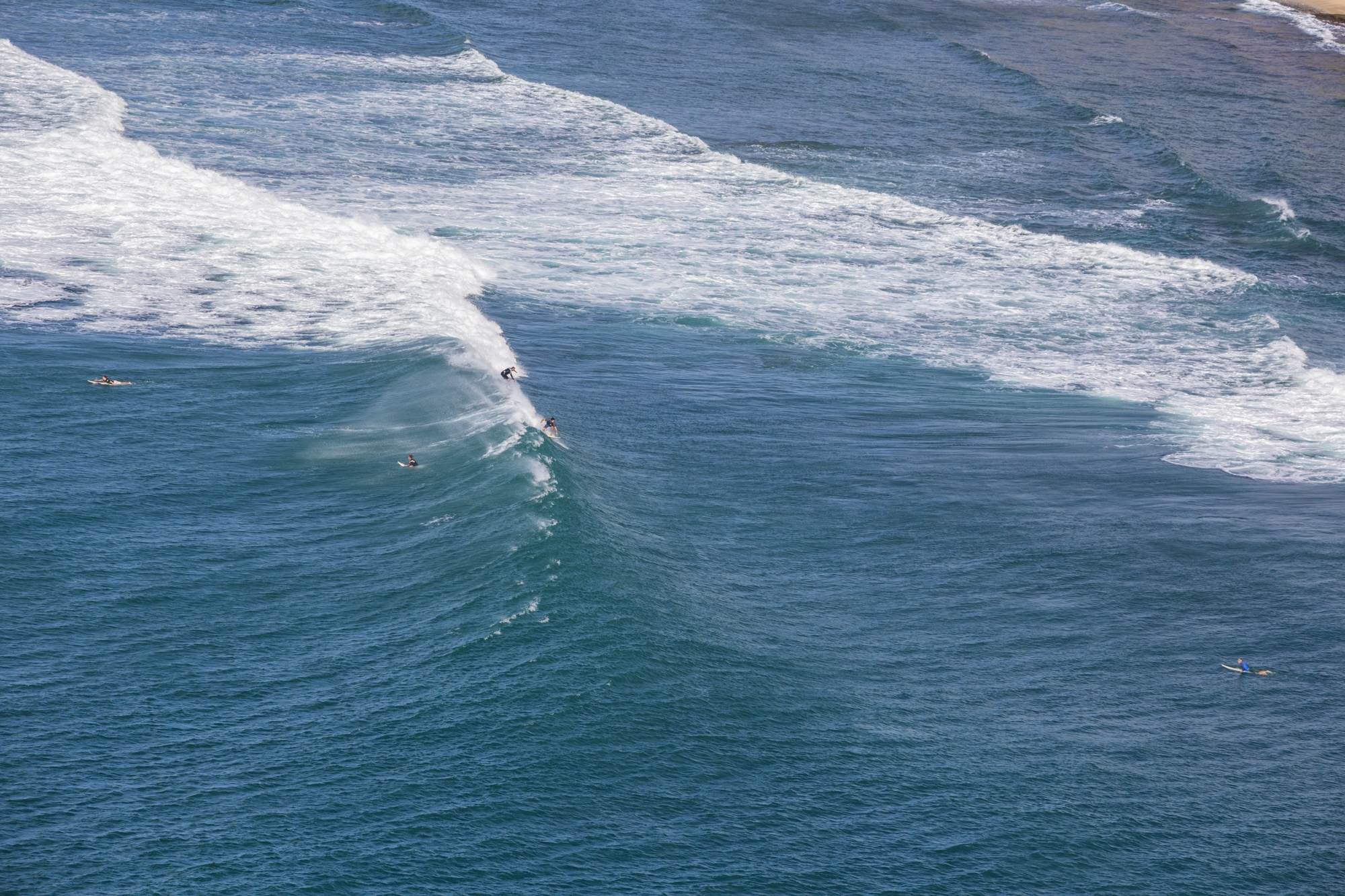 two surfers surfing waves