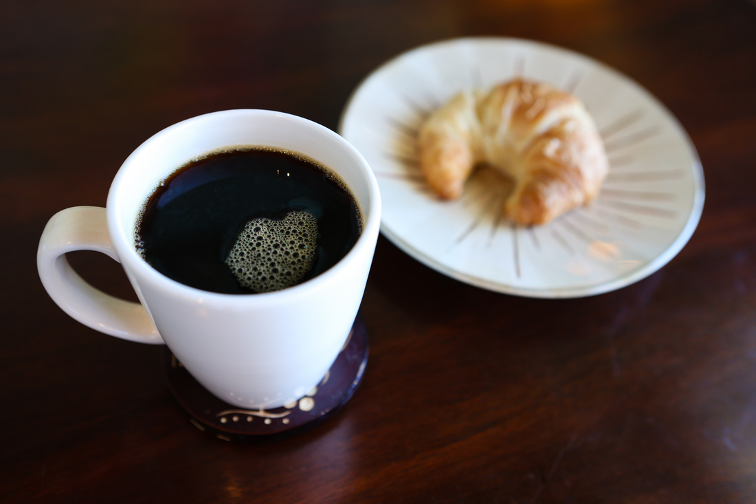 a cup of coffee and a pastry