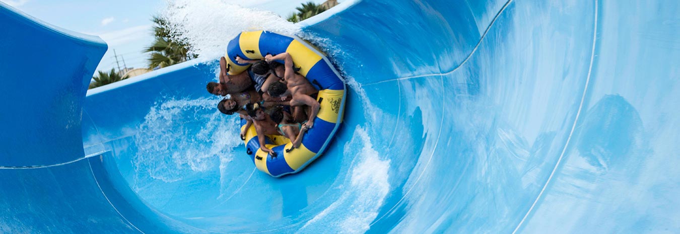 a group of people on a raft on a waterslide