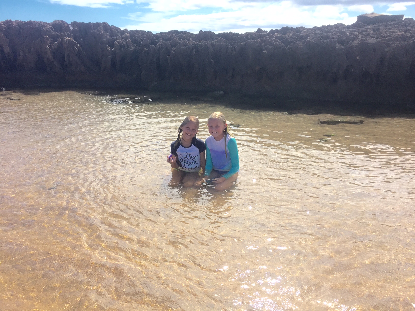 two children in a tide pool
