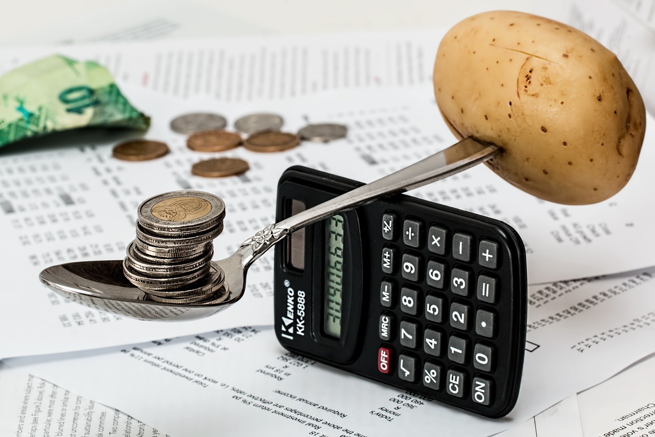 coins in a spoon and calculator