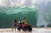 a lifeguard conversing with a beachgoer