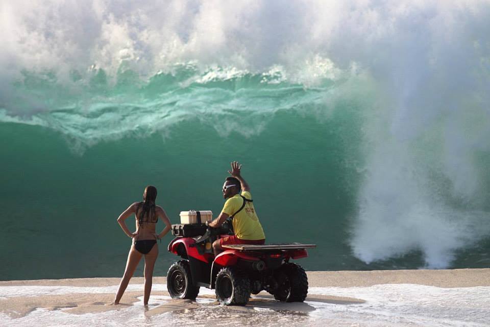 a lifeguard conversing with a beachgoer