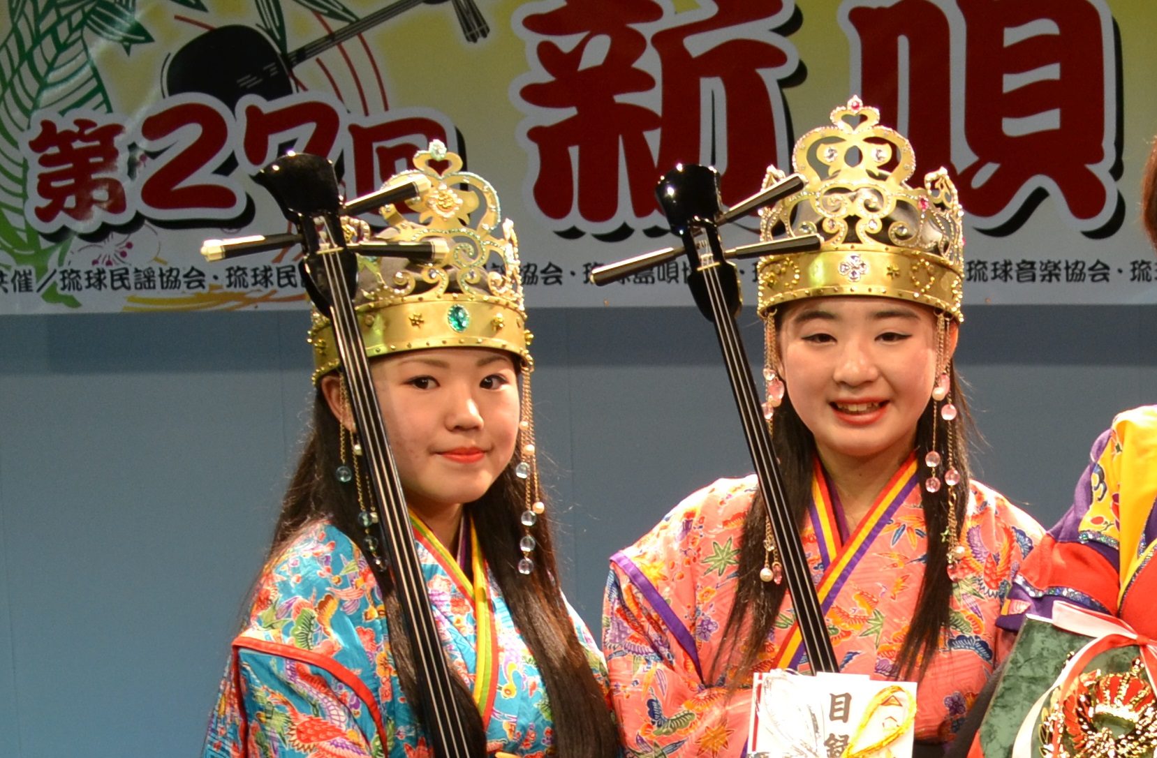 two girls dressed in okinawan clothes