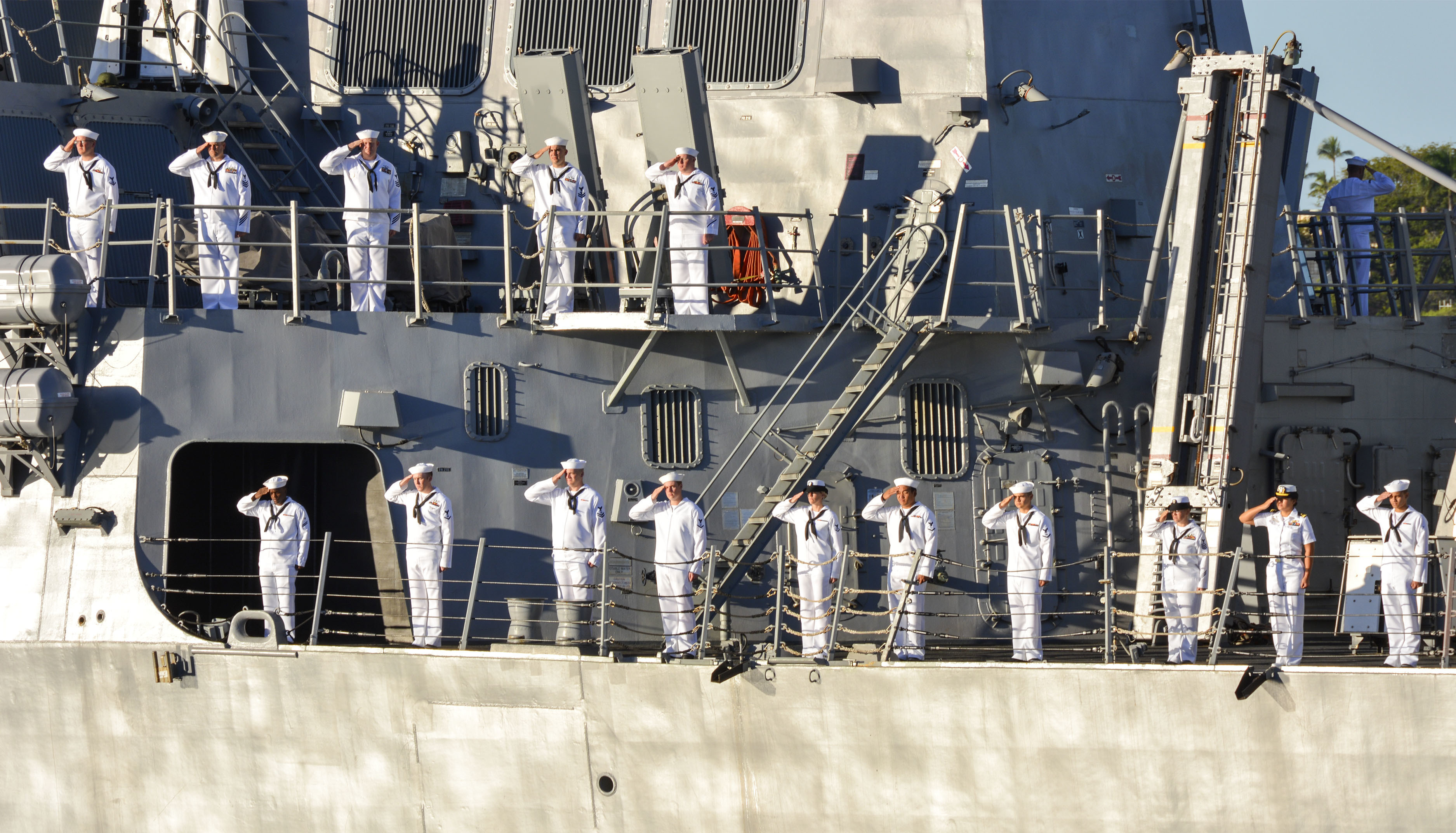 sailors saluting aboard a ship