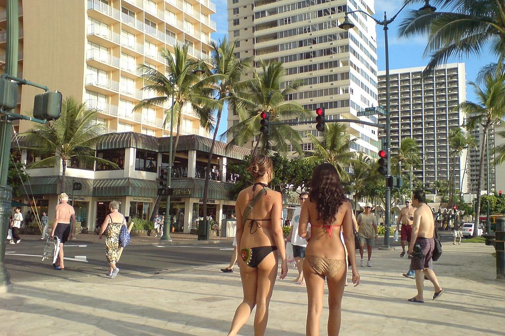 Beach goers walking along Waikiki street