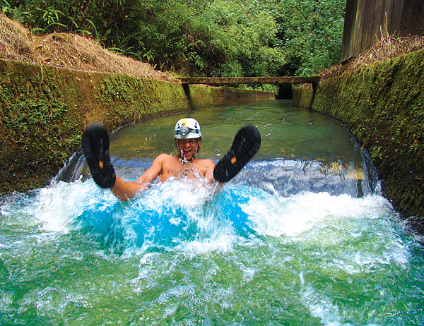 a man tubing in a flume