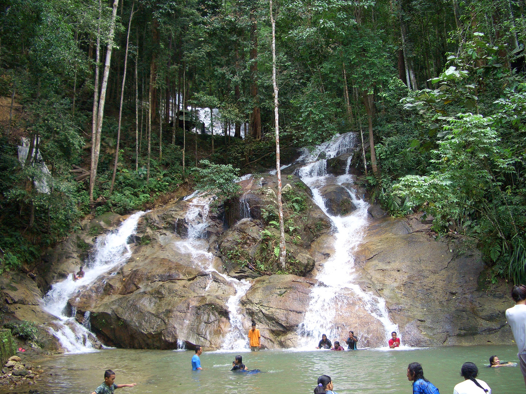 people playing in a waterfall