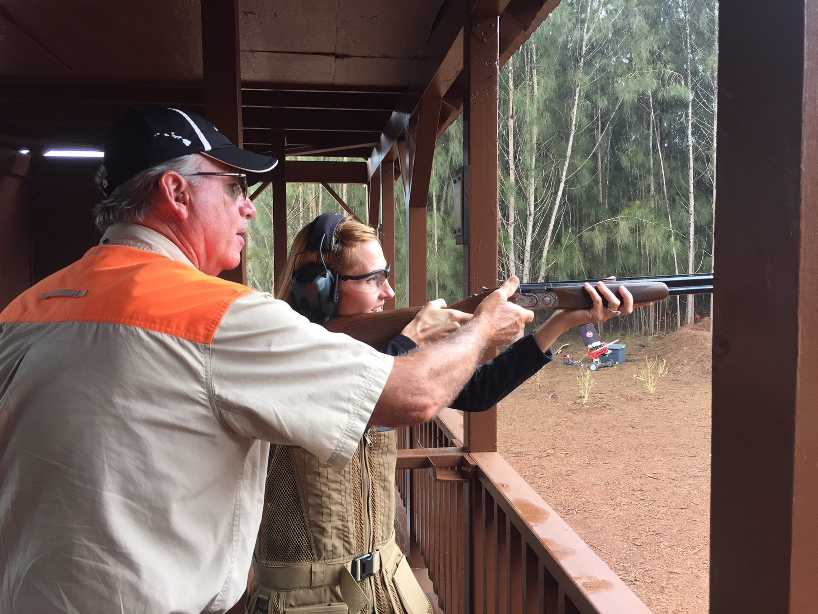 Person aiming gun at target