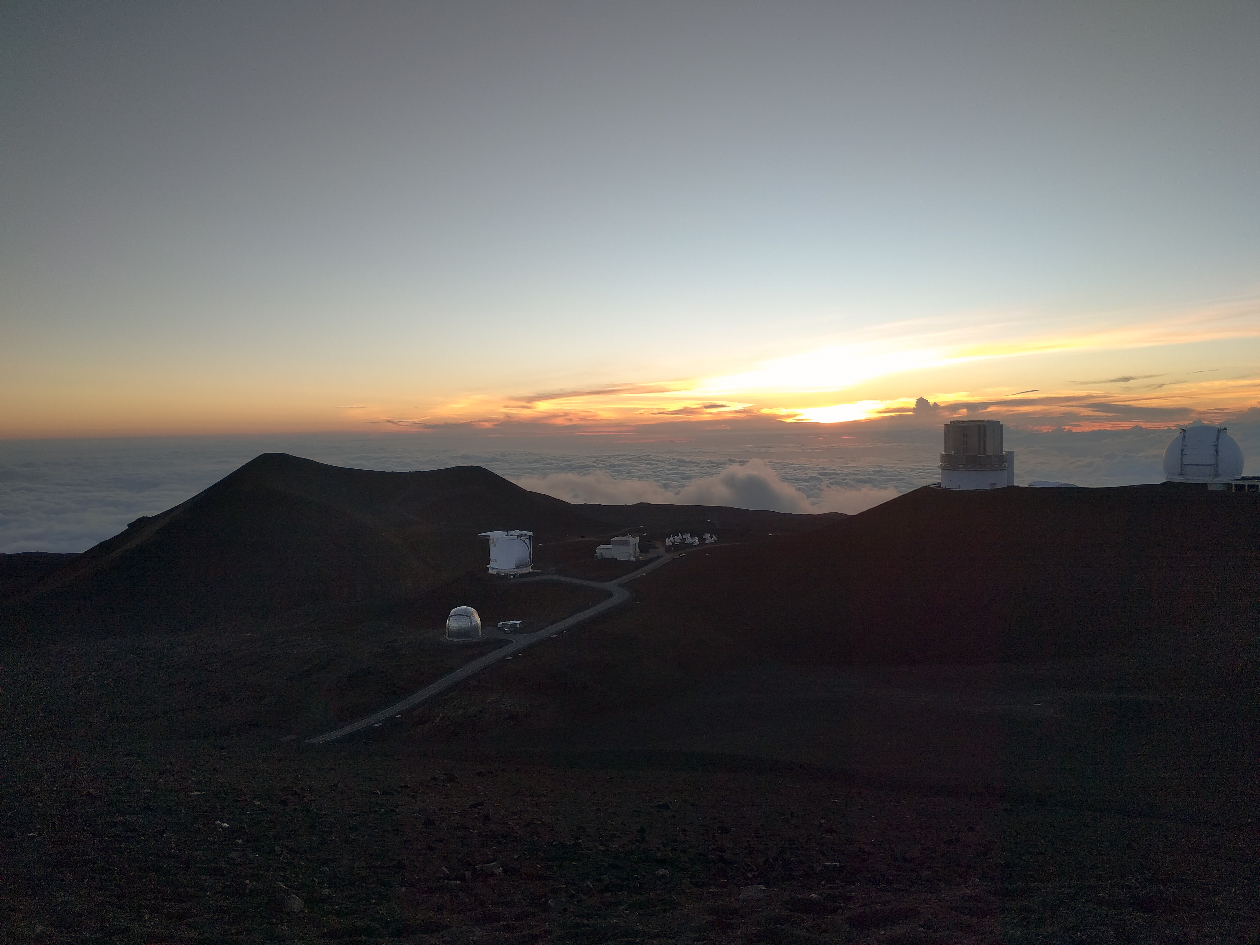 Watching the sunset from 14,000 feet above sea level on Mauna Kea. We were above the clouds! Afterwards, we went stargazing on Mauna Kea.