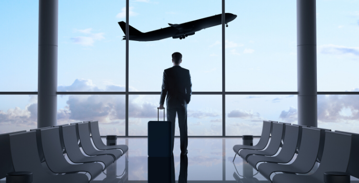Passenger looking out window at airport