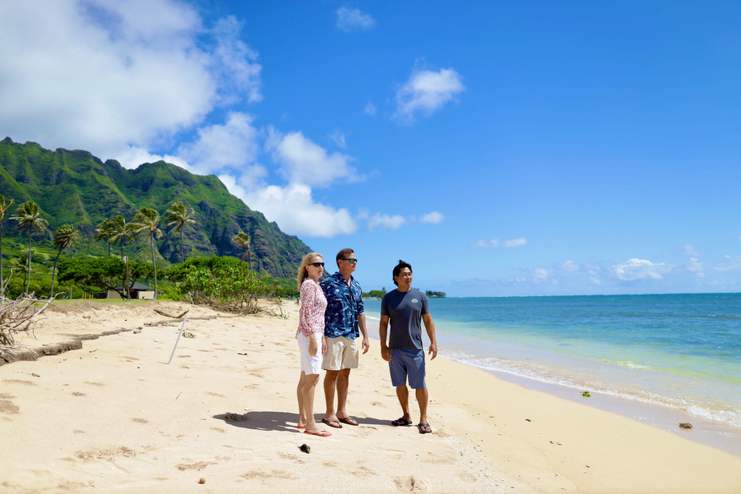 Couple and tour guide on the beach on Oahu