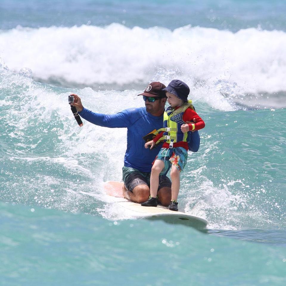 Man and Child surfing in Hawaii