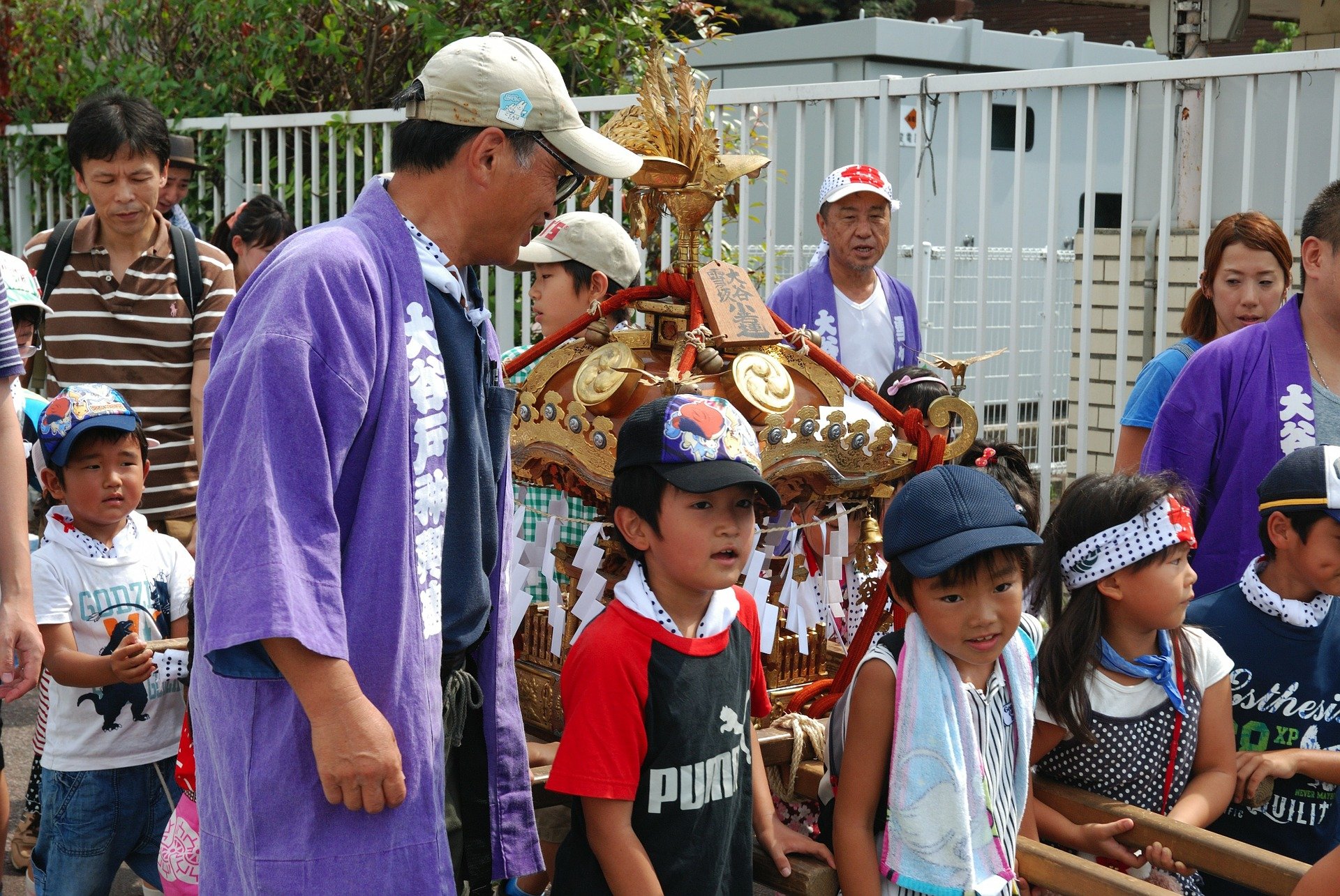 Japanese boys and girls with parents pulling traditional cart 