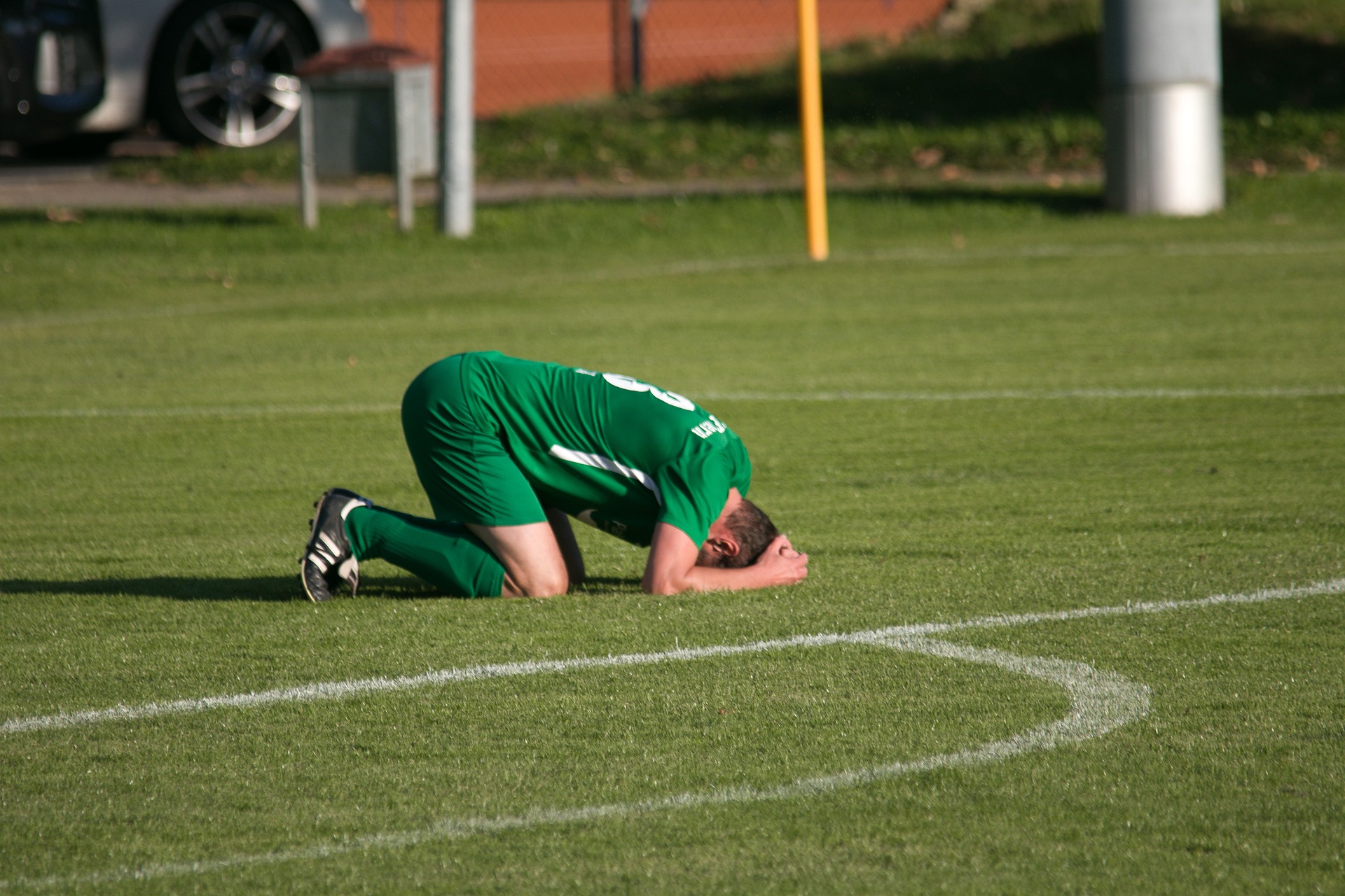 Soccer player with head toward ground
