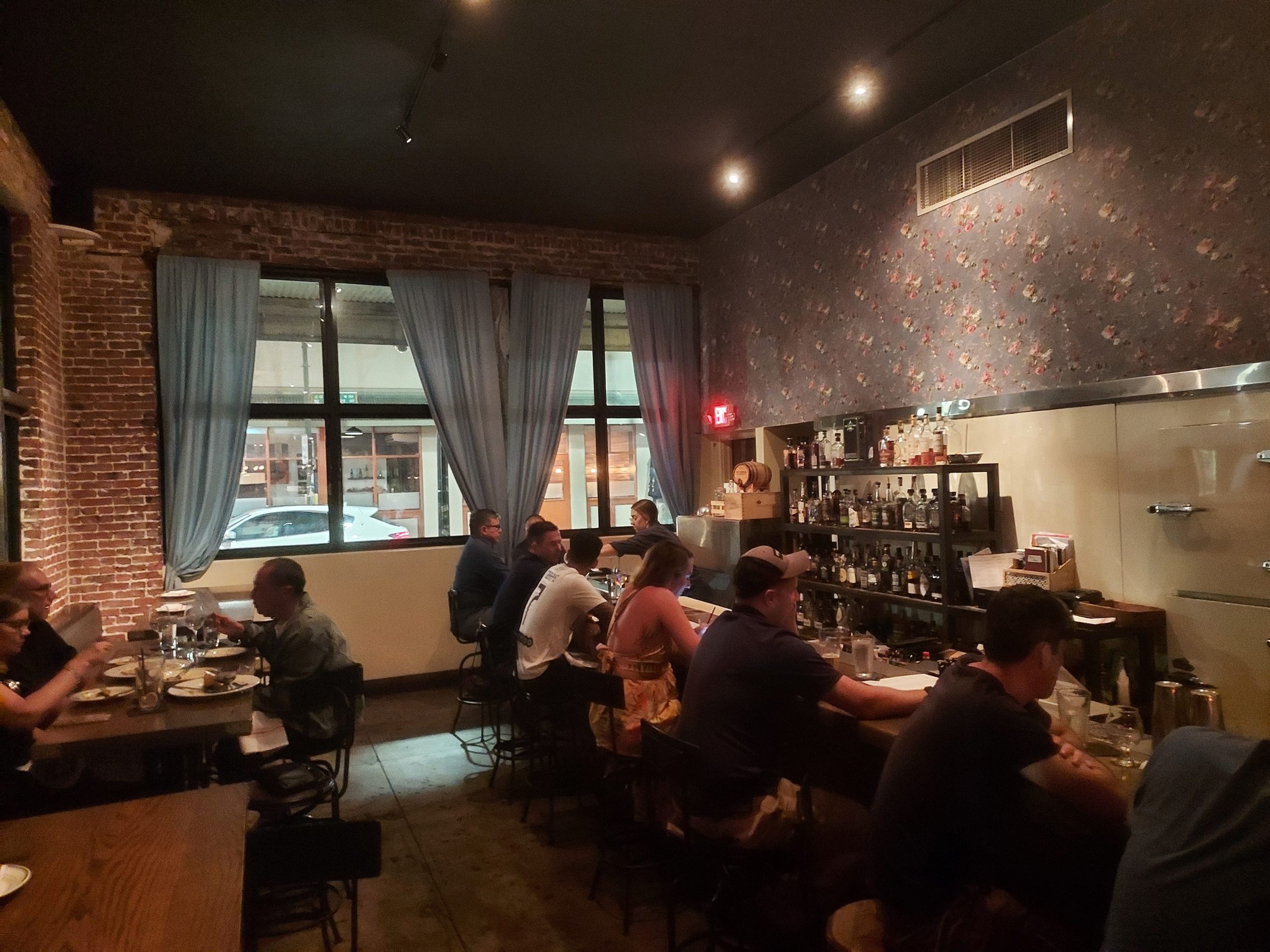 Tables and bar with people dining at Livestock tavern